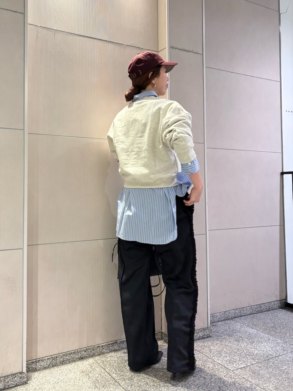 ベージュ系のスウェット、ブラック系のブーツ、ブラック系のショルダーバッグを着用したレディースの冬コーディネートの3枚目の写真