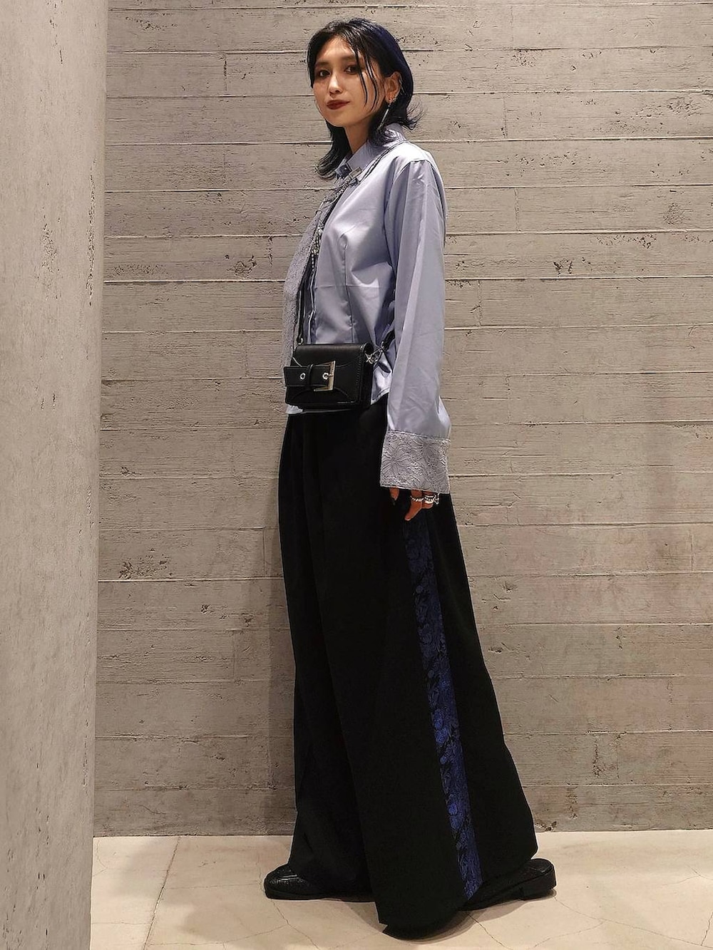 ブルー系のシャツ/ブラウス、ブラック系のショルダーバッグ、ブラック系のスラックスを着用したレディースの夏コーディネートの2枚目の写真