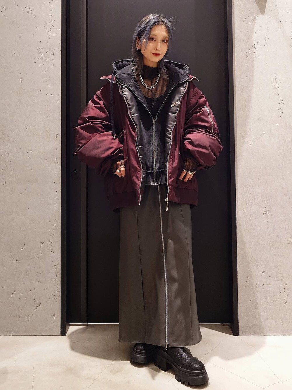 ブラック系のパーカー、ブラック系のブーツ、ブラック系のTシャツ/カットソーを着用したレディースの冬コーディネートの2枚目の写真