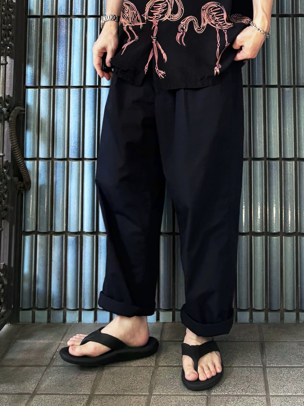 ブラック系のサンダル、ブラック系のシャツ/ブラウス、ブルー系のスラックスを着用したメンズの夏コーディネートの3枚目の写真