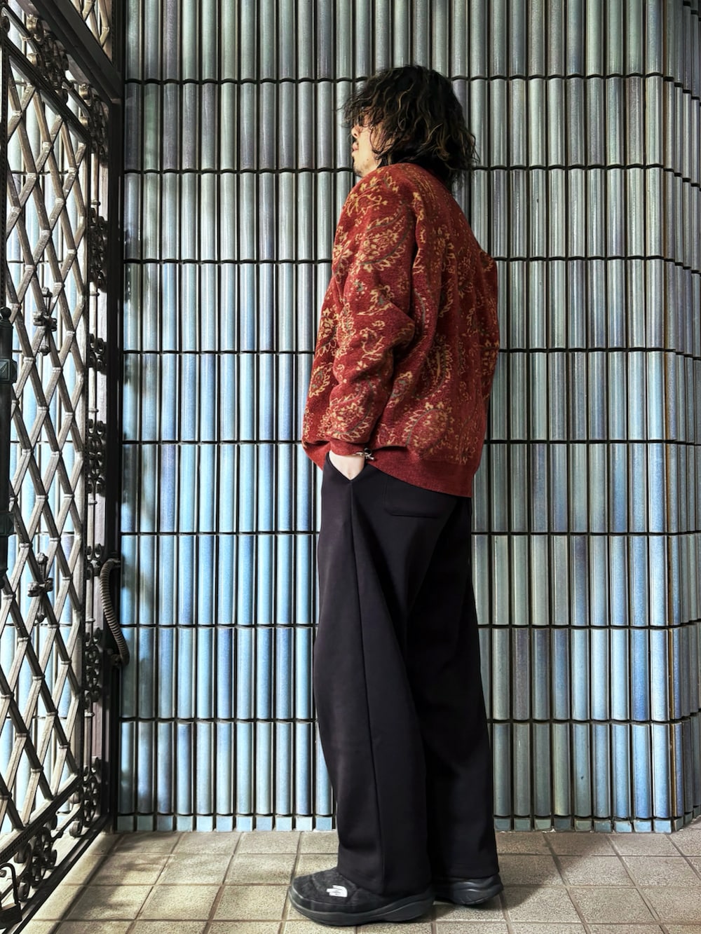 レッド系のカーディガン/ボレロ、ブラック系のスウェットパンツ、グレー系のブーツを着用したメンズの冬コーディネートの4枚目の写真