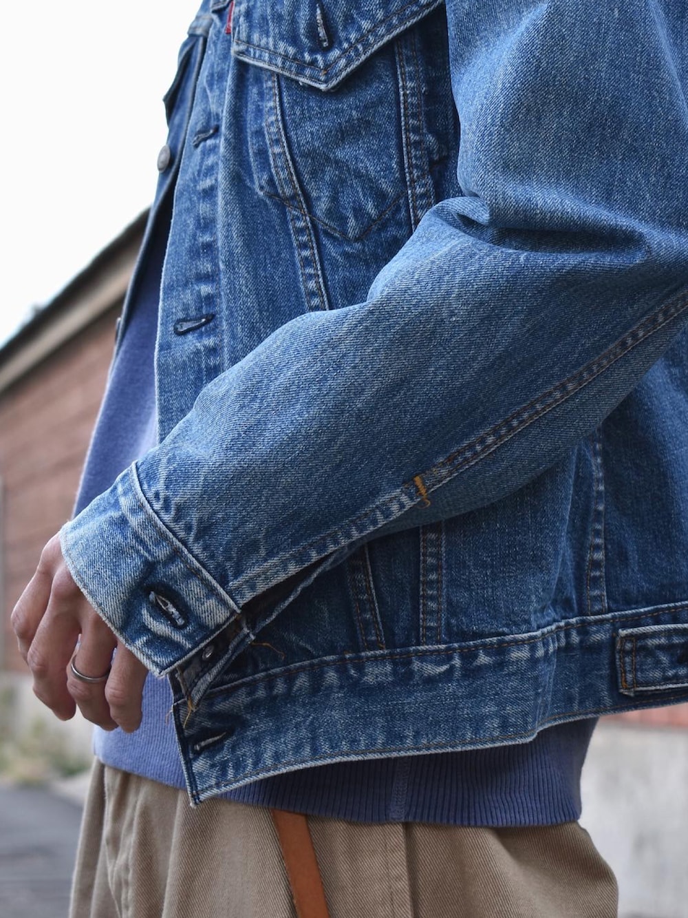 ブルー系のデニムジャケット、ブルー系のスウェット、グリーン系のチノパンツを着用したメンズの秋コーディネートの2枚目の写真