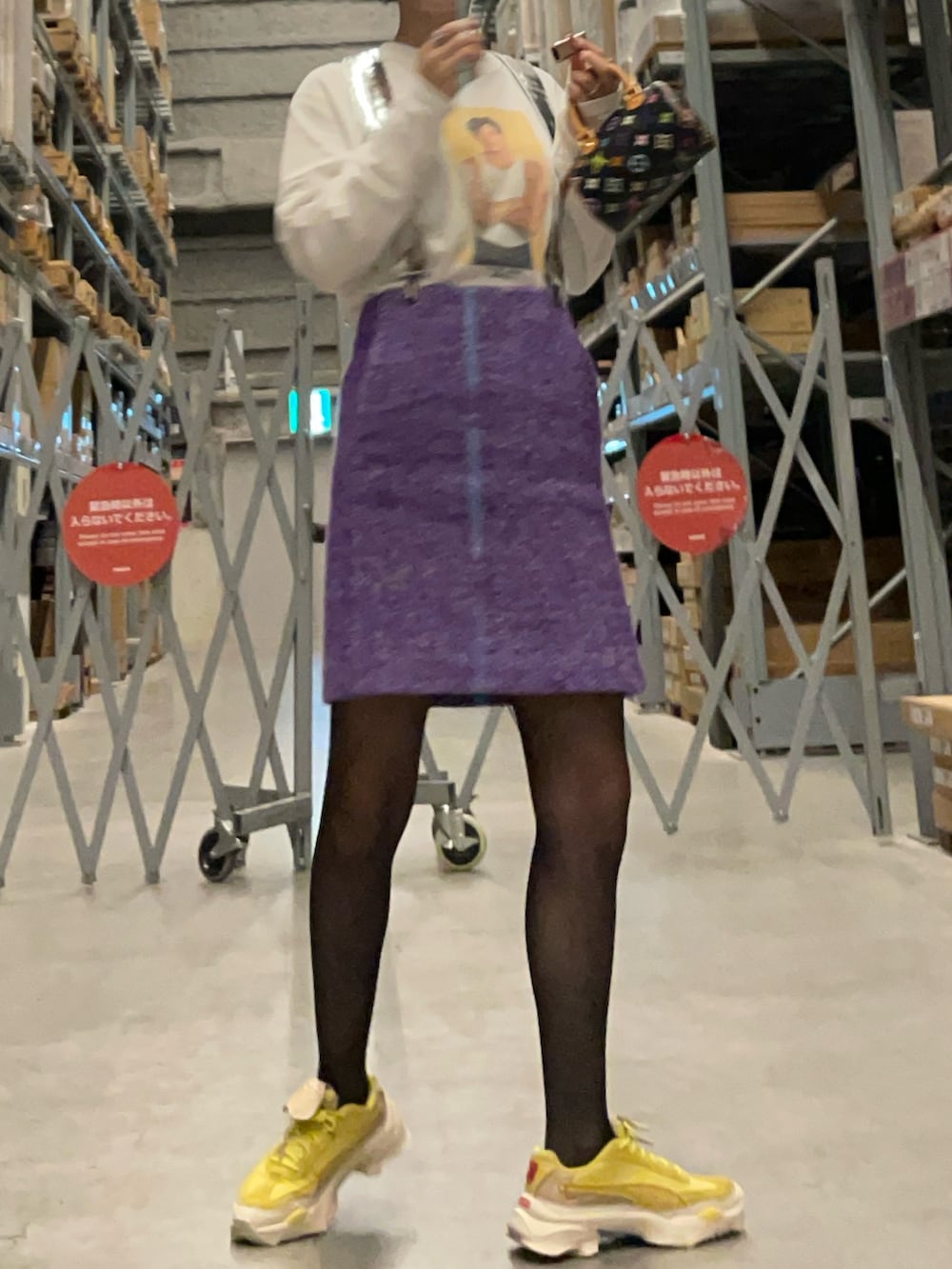 グリーン系のスニーカー、パープル系のスカート、ホワイト系のキャミソールを着用したレディースの秋コーディネートの2枚目の写真