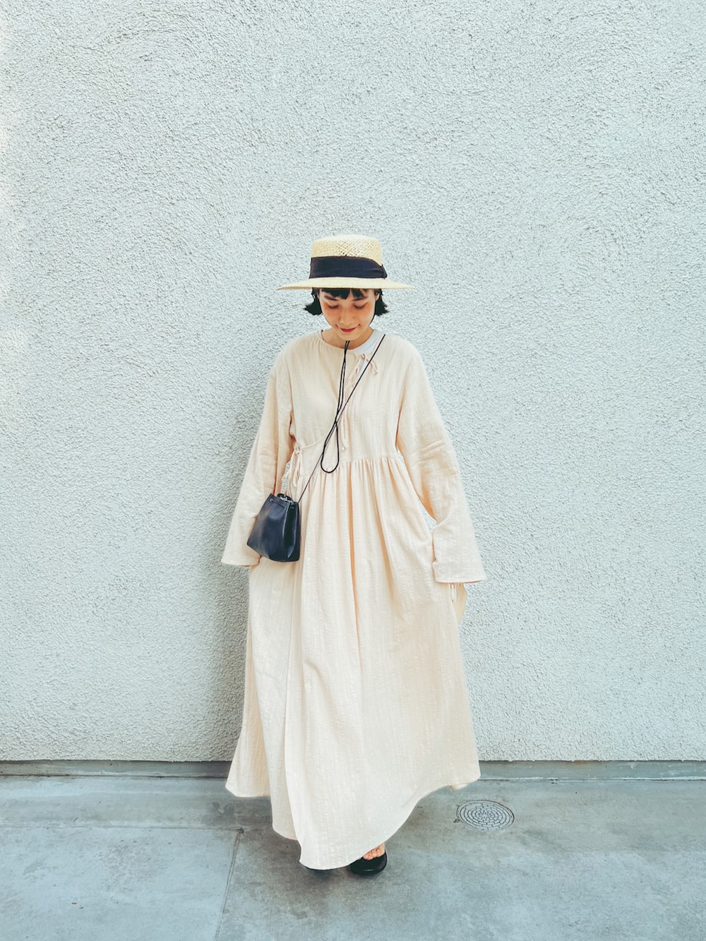 ホワイト系のワンピース/ドレス、ホワイト系のワンピース、ブラック系のサンダルを着用したレディースの夏コーディネートの2枚目の写真