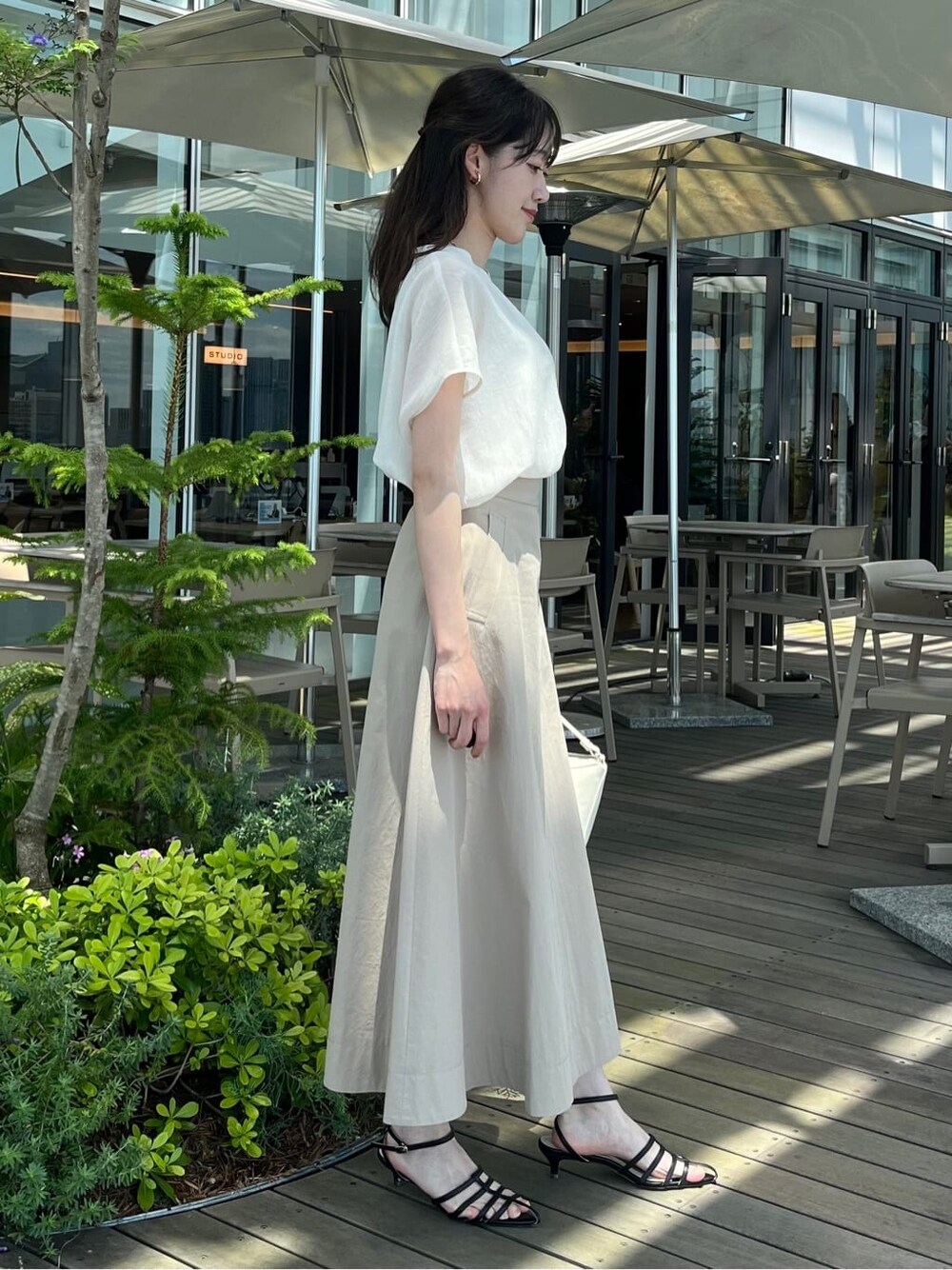 ベージュ系のストール/ショールを着用したレディースの夏コーディネートの7枚目の写真
