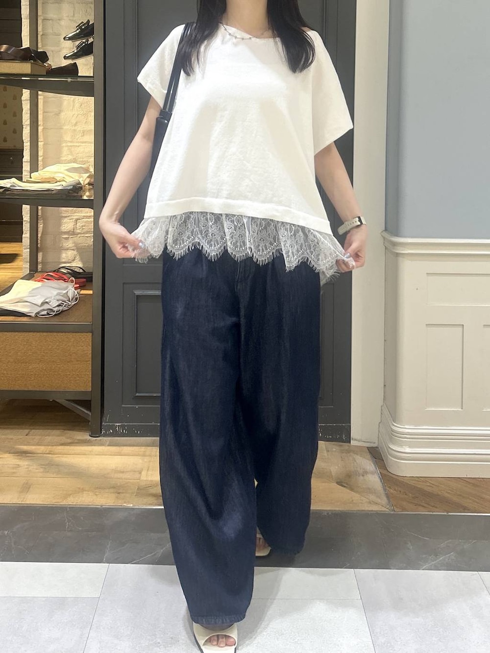 ブルー系のデニムパンツ、ホワイト系のパンプスを着用したレディースの夏コーディネートの4枚目の写真