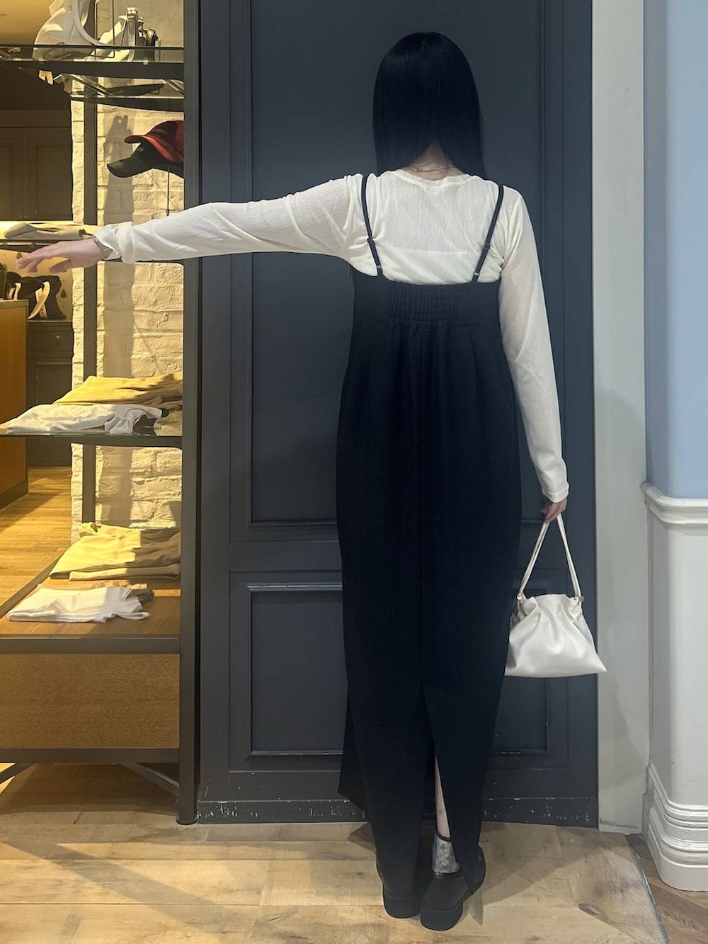 ホワイト系のショルダーバッグ、ブラック系のローファー、ホワイト系のTシャツ/カットソーを着用したレディースの秋コーディネートの3枚目の写真