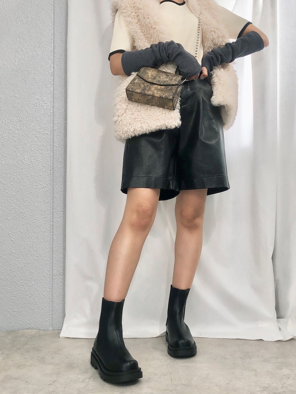 ブラック系のブーツ、グレー系のアームカバーを着用したレディースの秋コーディネートの2枚目の写真