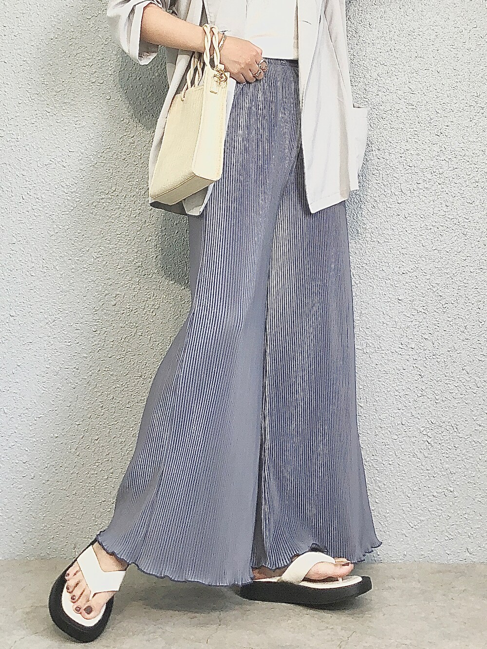 ホワイト系のサンダル、ホワイト系のショルダーバッグを着用したレディースの夏コーディネートの2枚目の写真