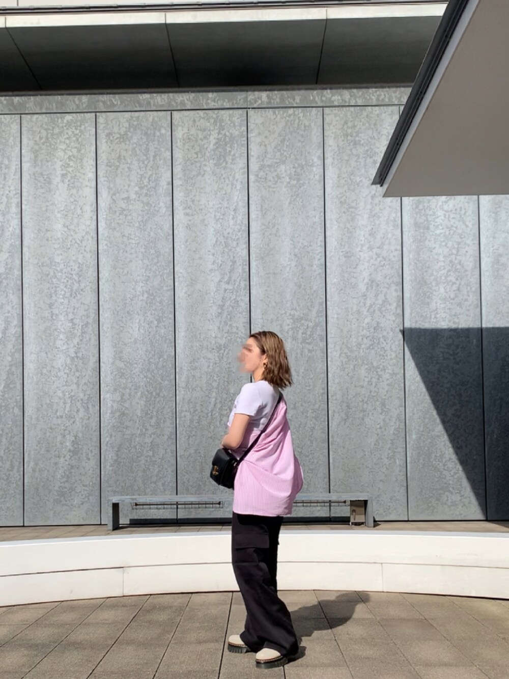 ブラック系のカーゴパンツ、ホワイト系のブーツ、ピンク系のジャケット/アウターを着用したレディースの春コーディネートの2枚目の写真