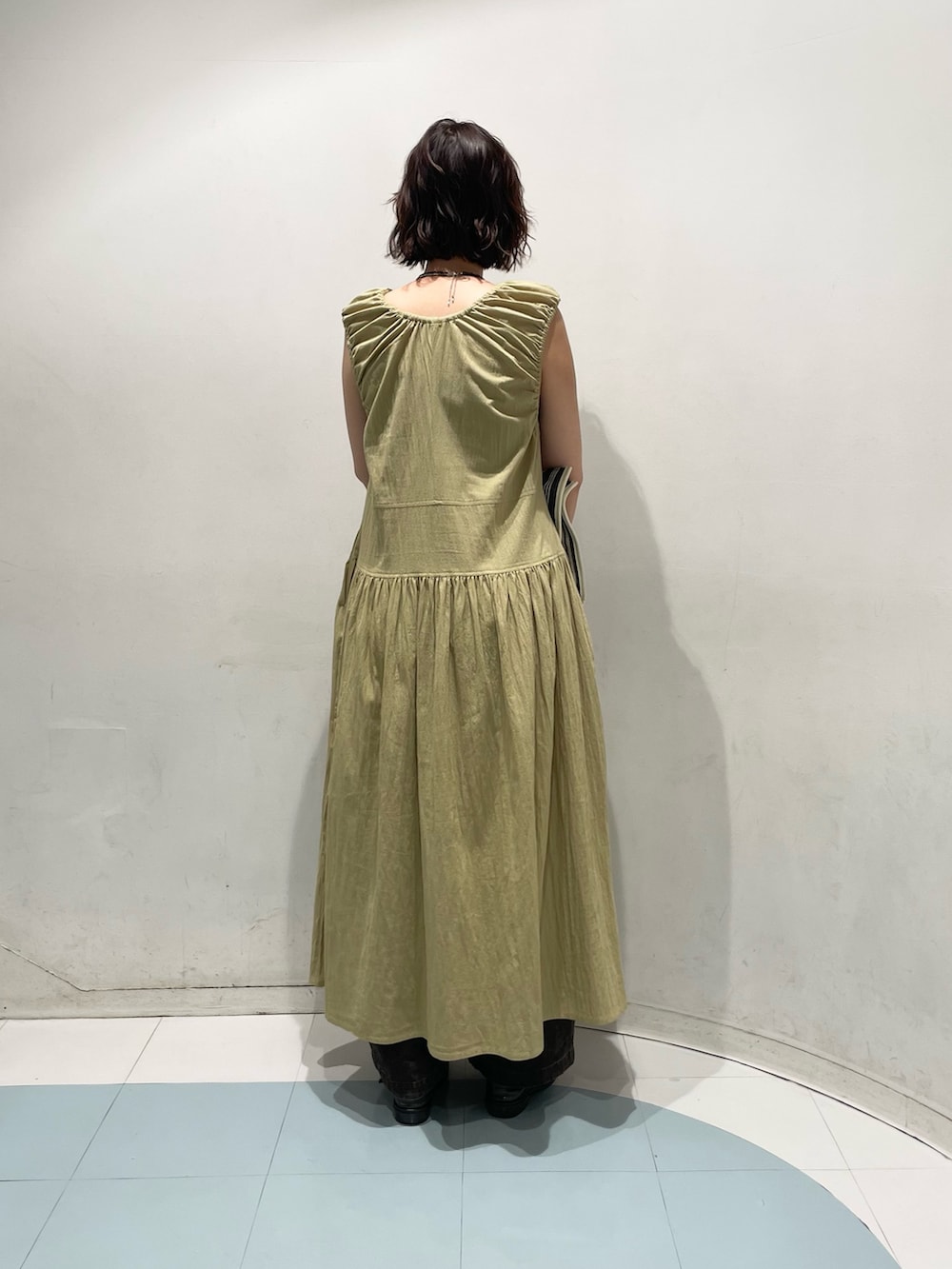ベージュ系のワンピース、ブラウン系のその他パンツ、ホワイト系のトートバッグを着用したレディースの夏コーディネートの2枚目の写真