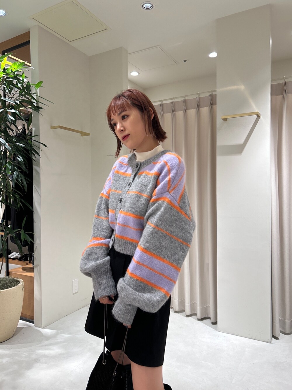 グレー系のニット/セーター、ホワイト系のTシャツ/カットソー、ブラック系のその他パンツを着用したレディースの秋コーディネートの3枚目の写真