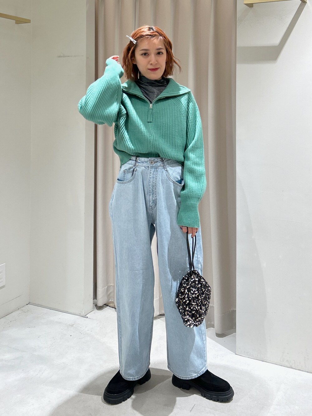 グリーン系のカーディガン/ボレロ、ブルー系のデニムパンツを着用したレディースの冬コーディネートの2枚目の写真