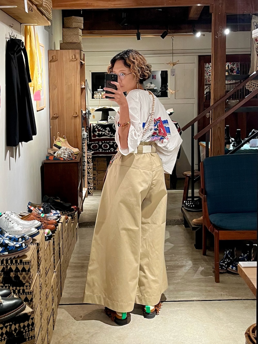 ベージュ系のパンツ、ホワイト系のTシャツ/カットソー、ピンク系のショルダーバッグを着用したレディースの春コーディネートの2枚目の写真
