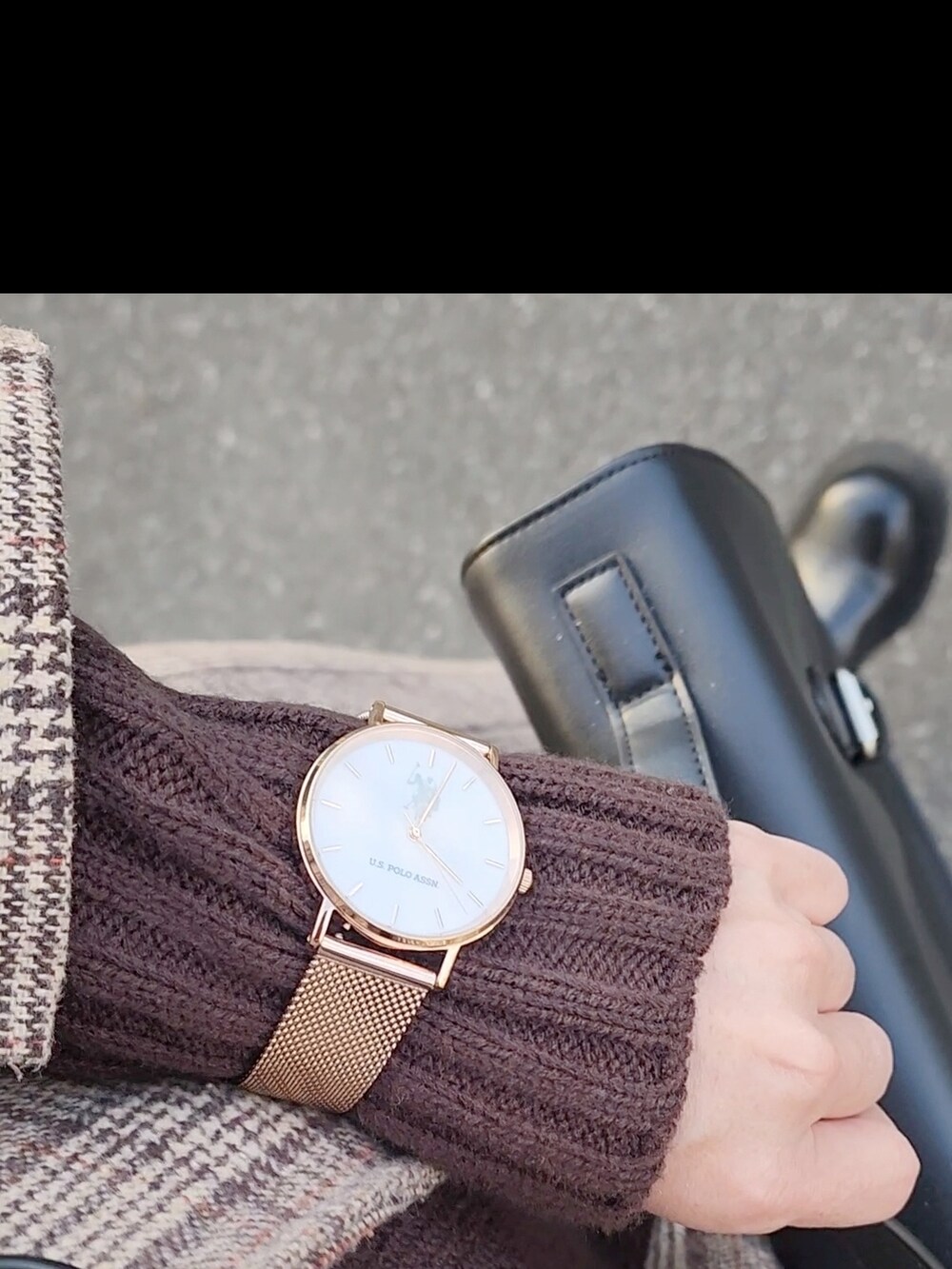 ブラウン系のチェスターコート、ブラウン系のニット/セーター、ブラック系のショルダーバッグを着用したレディースの冬コーディネートの4枚目の写真