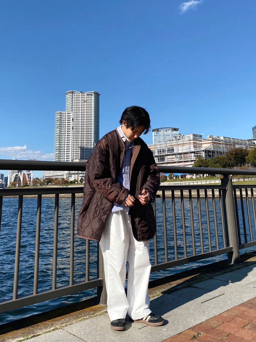 ブルー系のシャツ/ブラウス、ホワイト系のデニムパンツ、ブラウン系のジャケット/アウターを着用したレディースの冬コーディネートの2枚目の写真