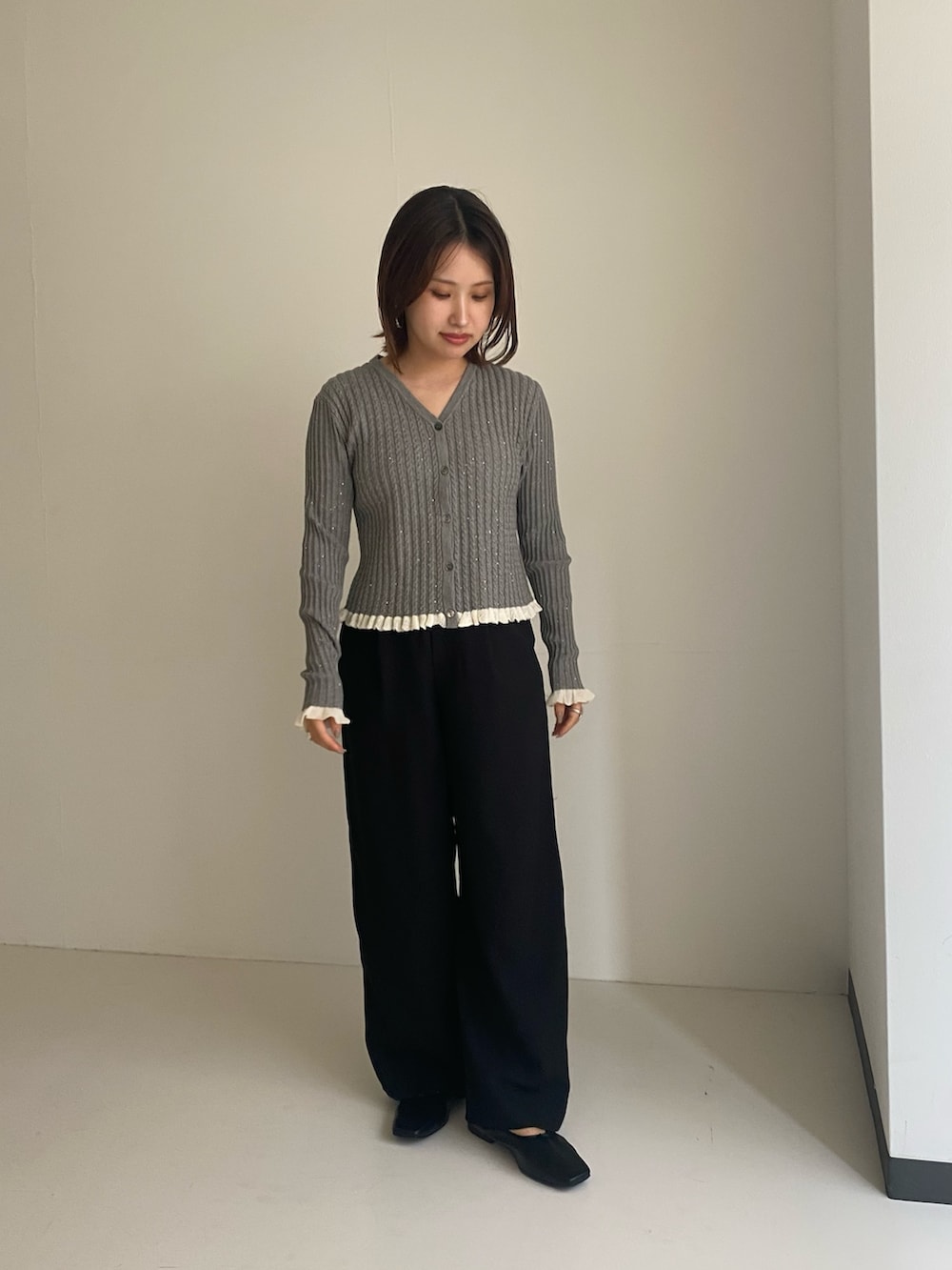 グレー系のカーディガン/ボレロ、ブラック系のその他パンツを着用したレディースの秋コーディネートの2枚目の写真