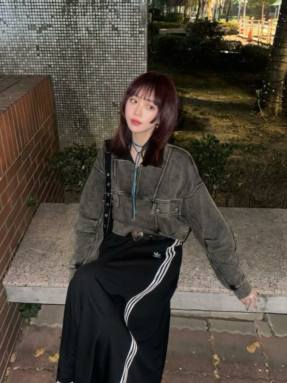 ブラック系のスウェット、ブラック系のスカート、ブラック系のシューズを着用したレディースの春コーディネートの3枚目の写真