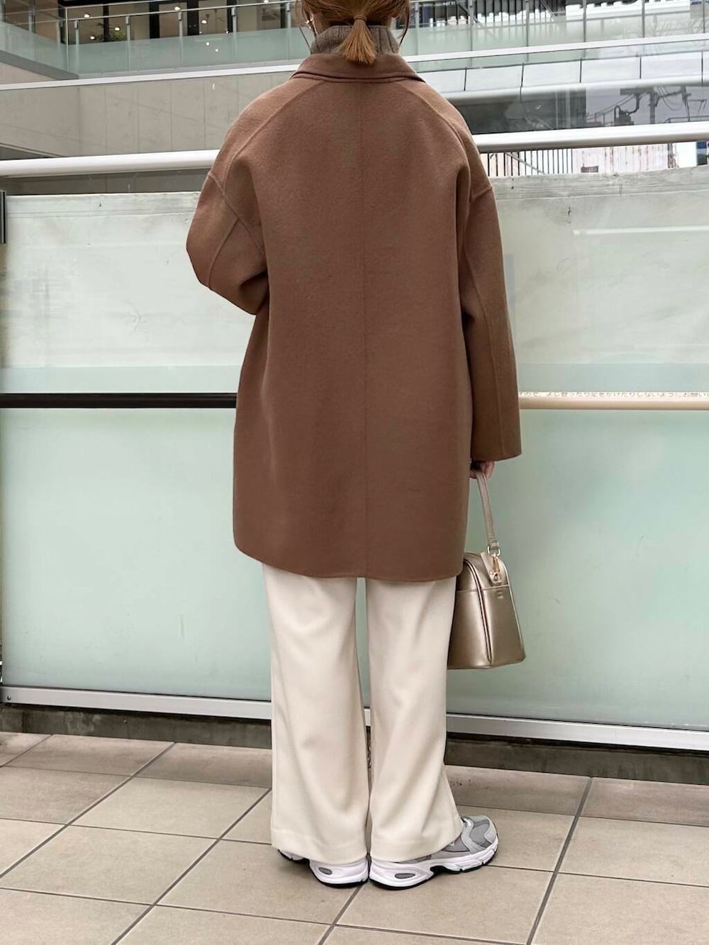 ブラウン系のその他アウター、ゴールド系のショルダーバッグ、ホワイト系のニット/セーターを着用したレディースの秋コーディネートの4枚目の写真