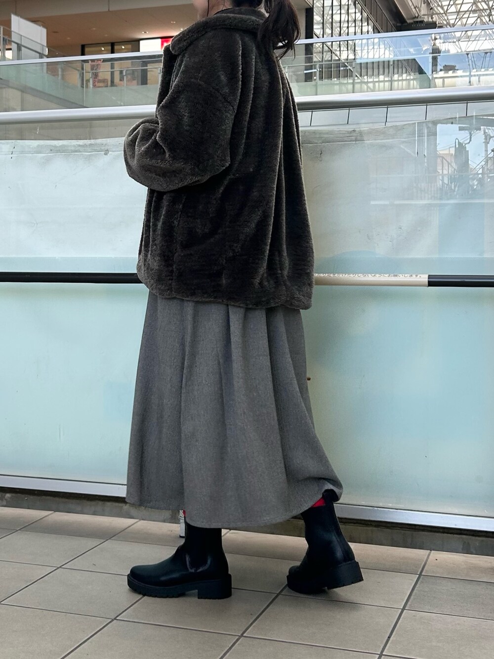 グレー系のその他アウター、グレー系のワンピース、ベージュ系のショルダーバッグを着用したレディースの冬コーディネートの3枚目の写真