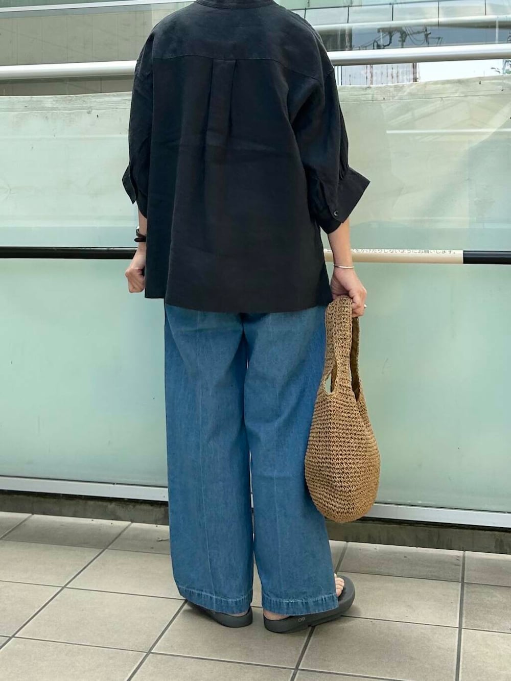 イエロー系のトートバッグ、グレー系のシャツ/ブラウス、グレー系のサンダルを着用したレディースの春コーディネートの4枚目の写真