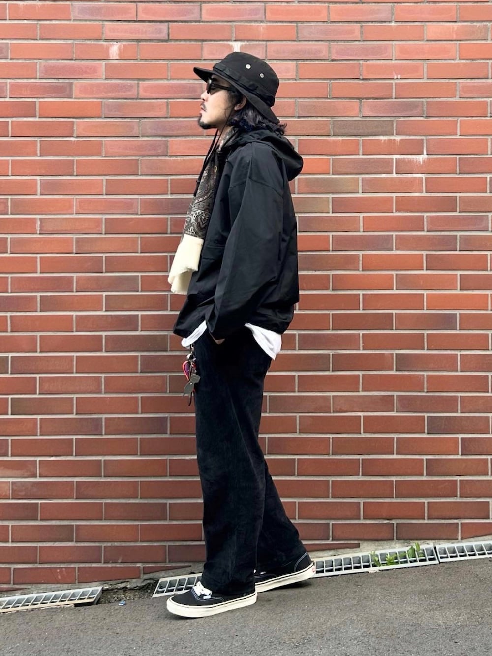 ブラック系のマウンテンパーカー、ブラック系のその他パンツ、ブラック系のスニーカーを着用したメンズの秋コーディネートの2枚目の写真