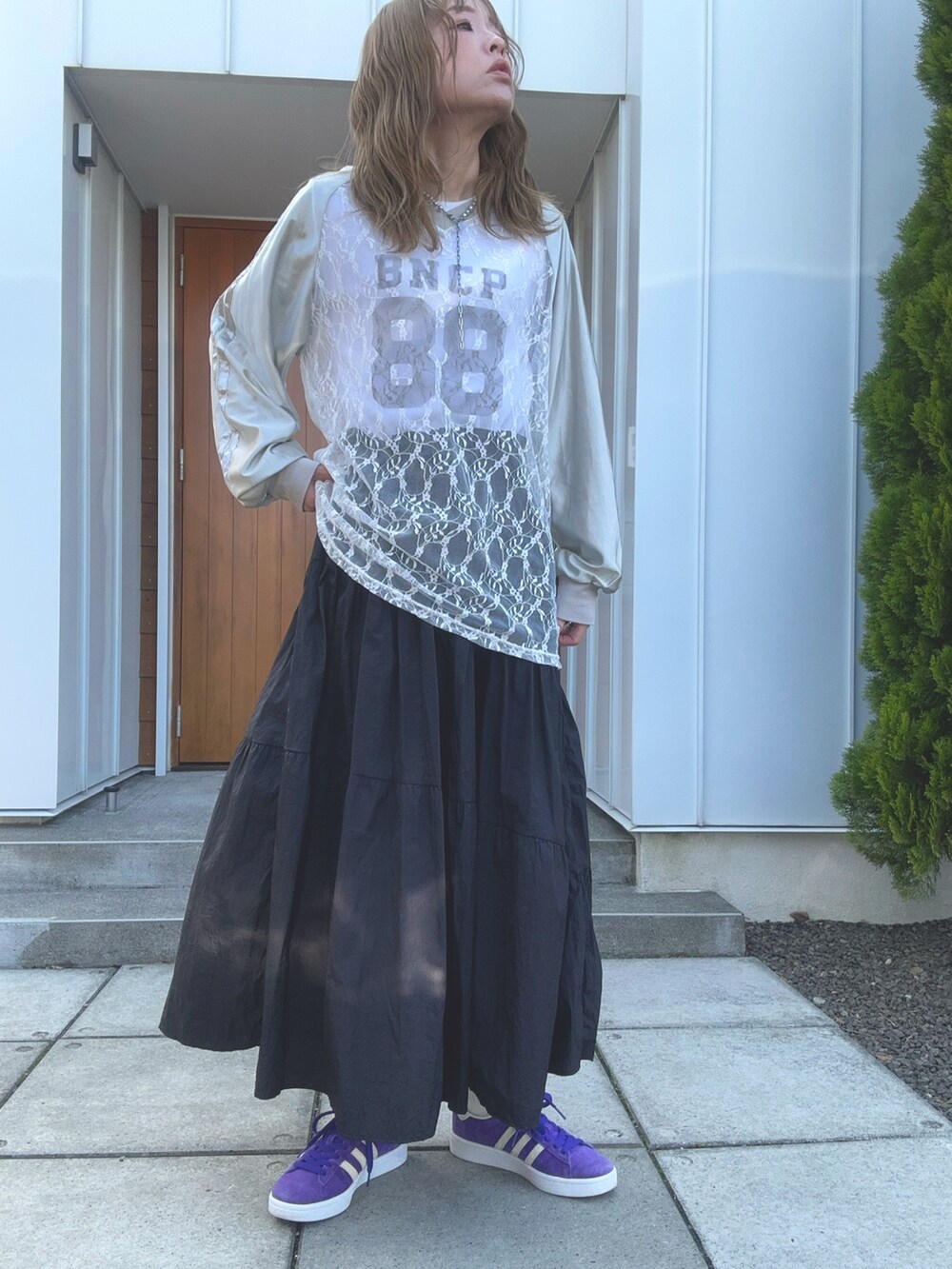 グレー系のTシャツ/カットソー、ブラック系のスカートを着用したレディースの春コーディネートの2枚目の写真