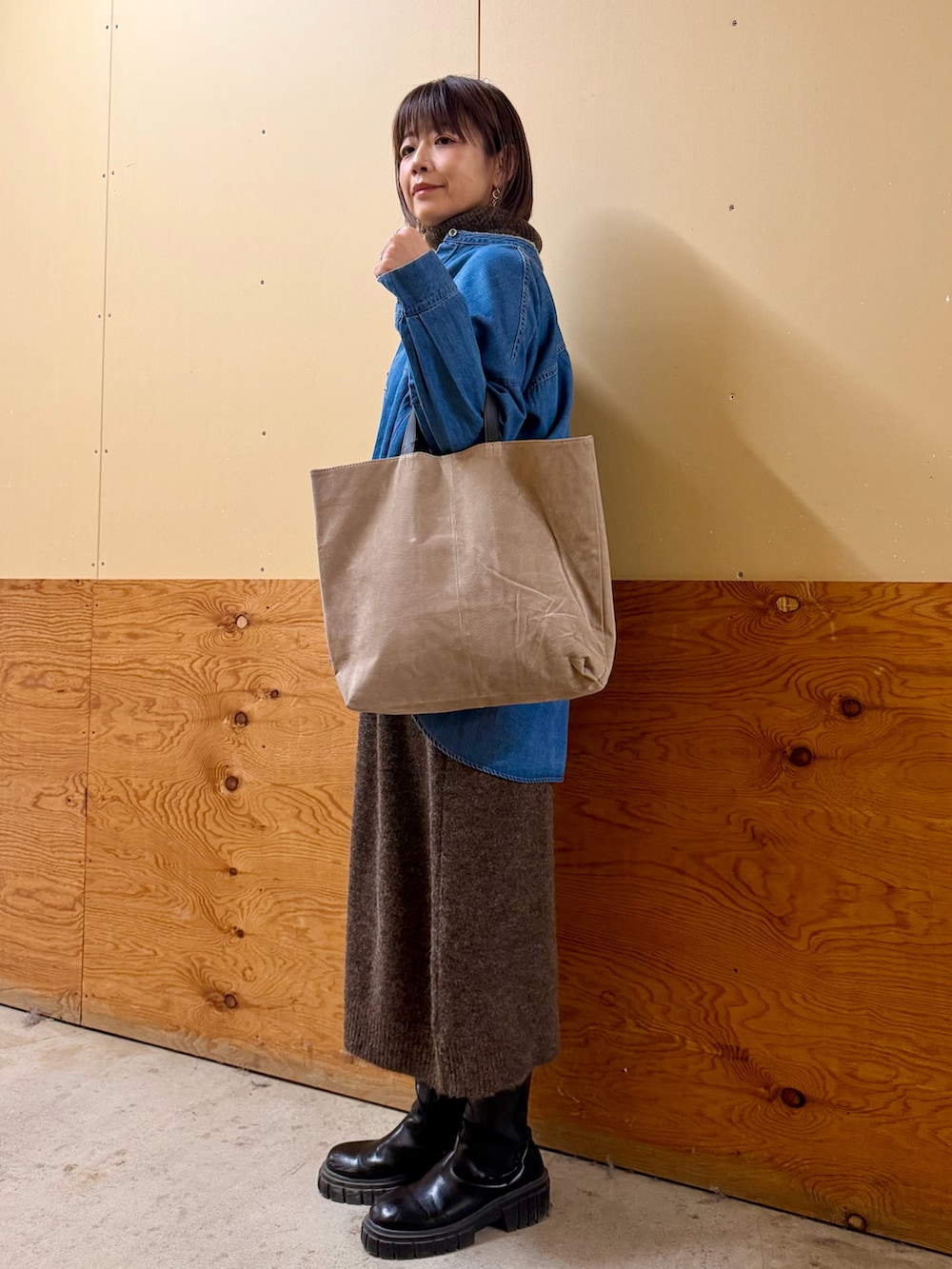 ブラウン系のワンピース、ブルー系のシャツ/ブラウス、グレー系のトートバッグを着用したレディースの冬コーディネートの3枚目の写真