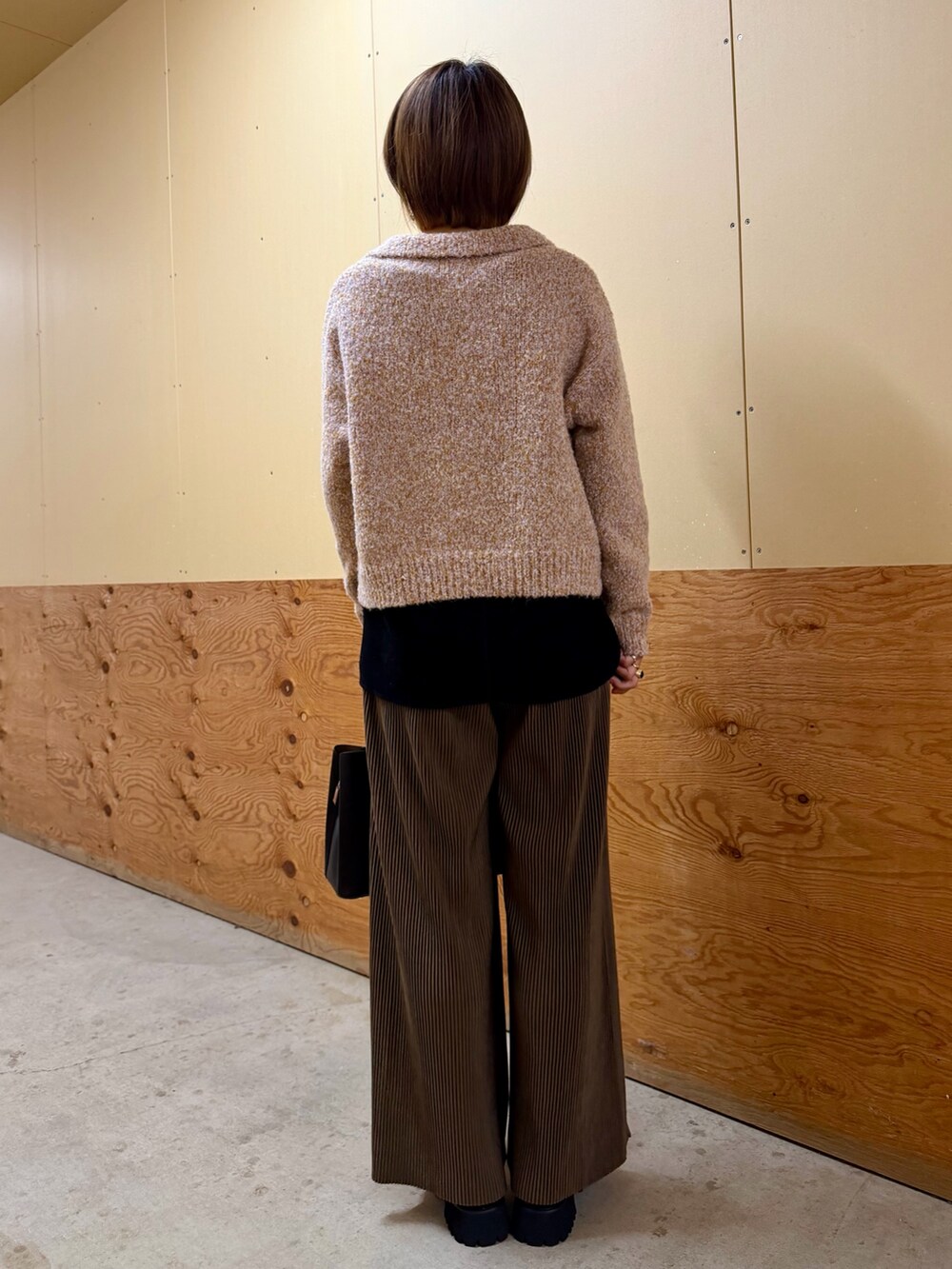 ピンク系のニット/セーター、ブラウン系のその他パンツ、ブラック系のTシャツ/カットソーを着用したレディースの秋コーディネートの5枚目の写真