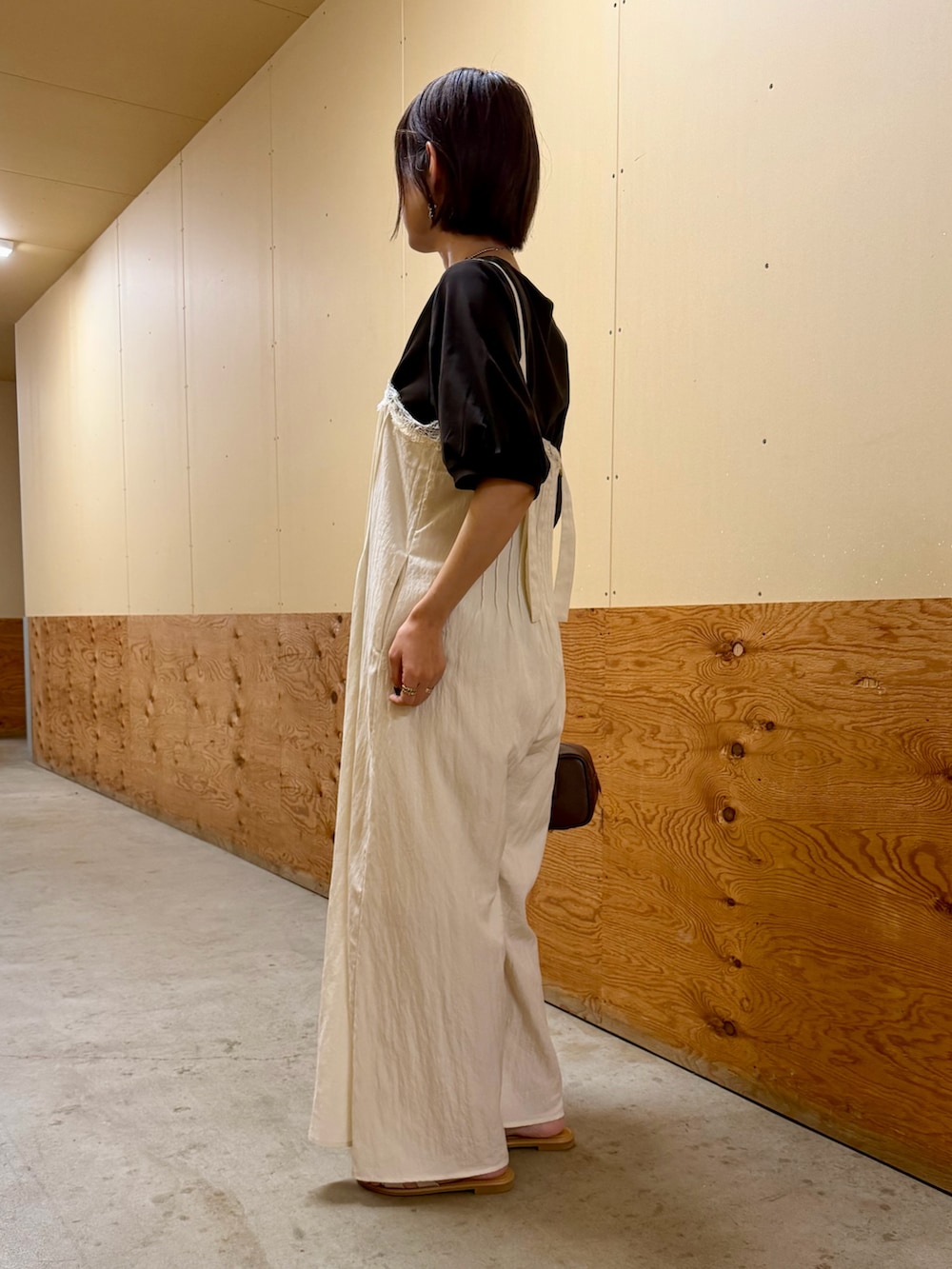 ブラウン系のTシャツ/カットソー、ホワイト系のその他パンツ、ブラウン系のハンドバッグを着用したレディースの夏コーディネートの2枚目の写真