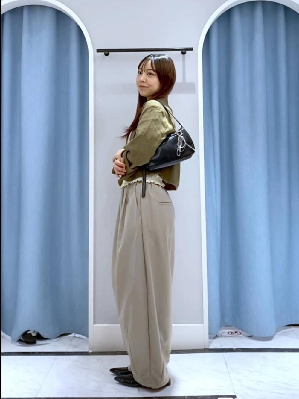 ブラウン系のテーラードジャケット、ブラック系のトートバッグ、ブラック系のパンプスを着用したレディースの春コーディネートの2枚目の写真