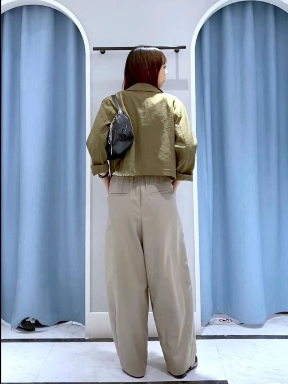 ブラウン系のテーラードジャケット、ブラック系のトートバッグ、ブラック系のパンプスを着用したレディースの春コーディネートの3枚目の写真