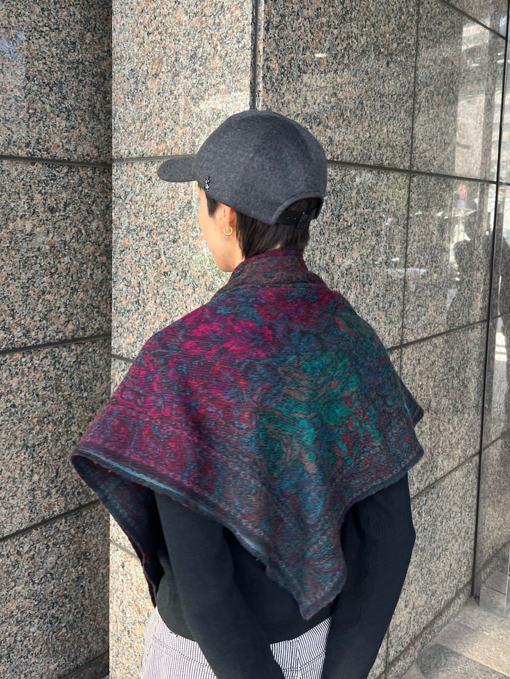 グレー系のデニムパンツ、ブラック系のブーツ、グレー系のキャップを着用したレディースの冬コーディネートの4枚目の写真