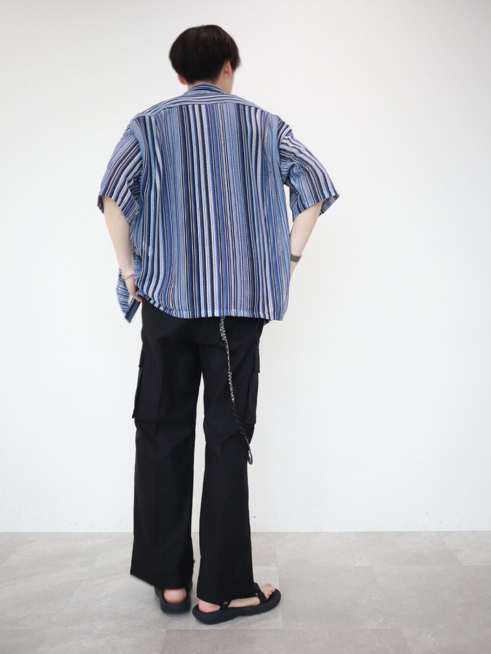 ブルー系のシャツ/ブラウス、ブラック系のカーゴパンツ、ブラック系のサンダルを着用したメンズの夏コーディネートの4枚目の写真