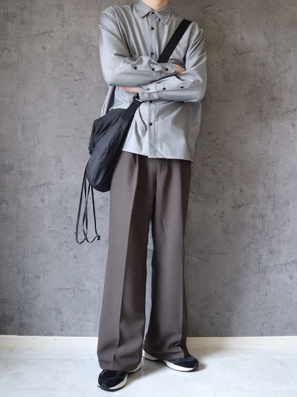 グレー系のシャツ/ブラウス、グレー系のスラックス、ブラック系のスニーカーを着用したメンズの春コーディネートの2枚目の写真