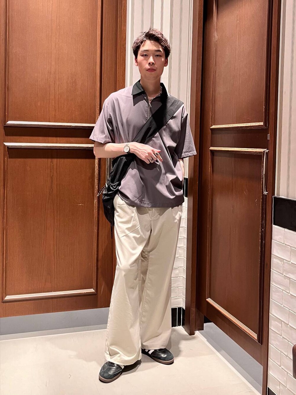 ホワイト系のスラックス、ブラック系のショルダーバッグ、グレー系のシャツ/ブラウスを着用したメンズの夏コーディネートの2枚目の写真