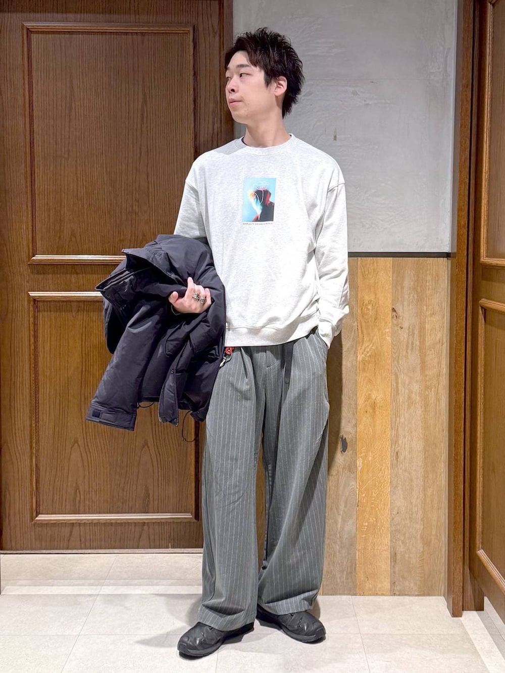 ブルー系のダウンジャケット/コート、その他のスウェット、グレー系のスラックスを着用したメンズの冬コーディネートの2枚目の写真