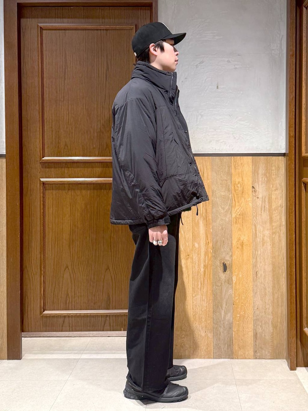 ブラック系のデニムパンツ、グリーン系のニット/セーター、ブラック系のダウンジャケット/コートを着用したメンズの冬コーディネートの7枚目の写真