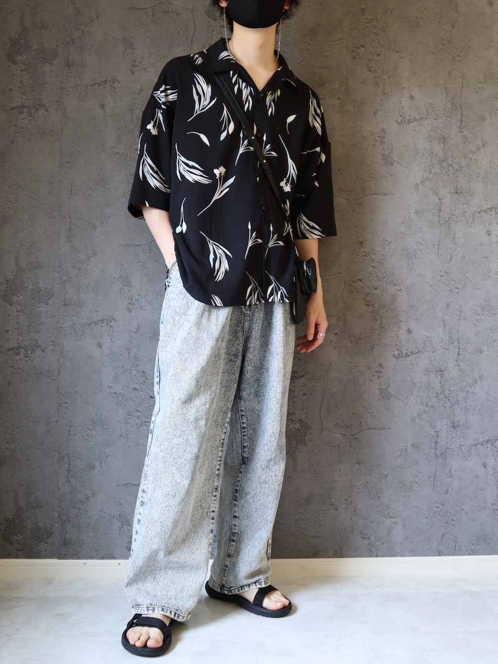 ブルー系のデニムパンツ、ブラック系のサンダル、ブラック系のシャツ/ブラウスを着用したメンズの春コーディネートの2枚目の写真