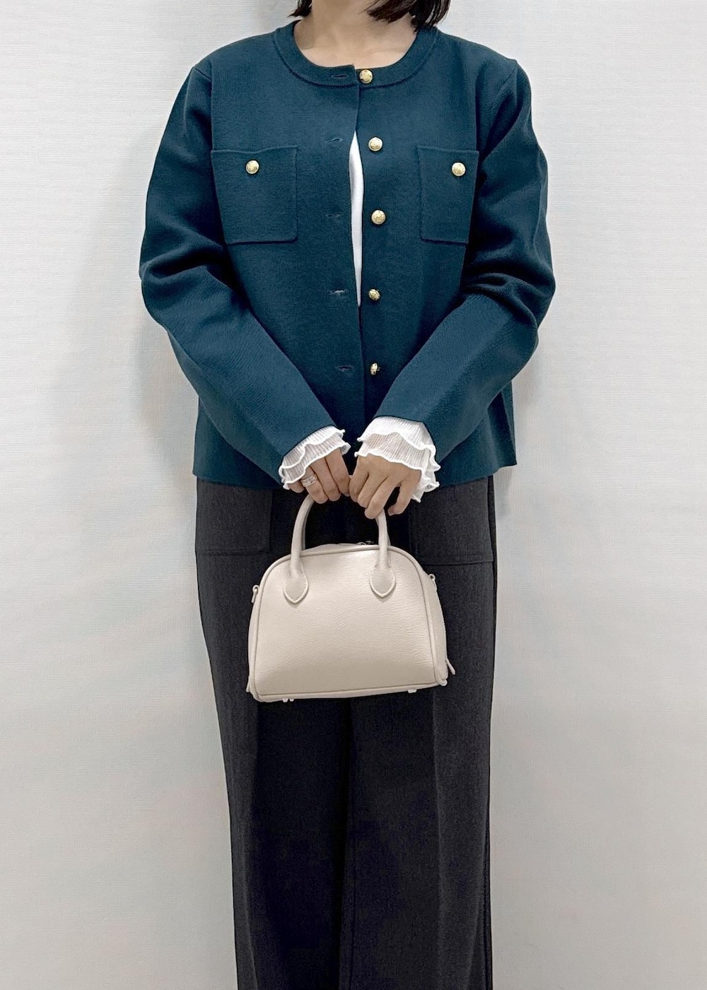 グレー系のその他パンツ、グリーン系のカーディガン/ボレロ、ブラック系のローファーを着用したレディースの秋コーディネートの9枚目の写真