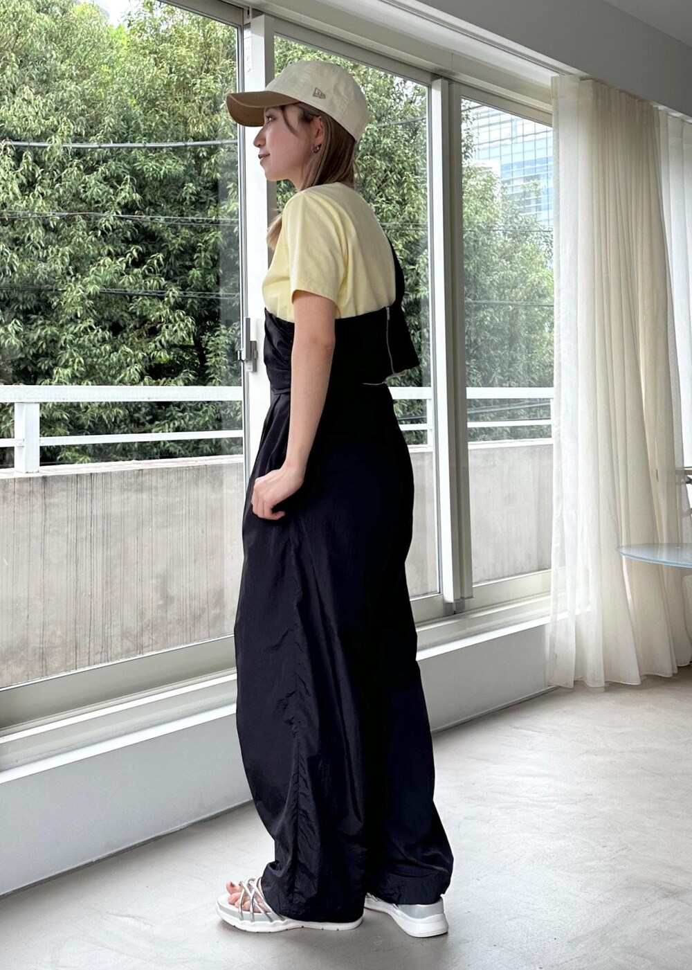 シルバー系のサンダル、グレー系のベスト、イエロー系のTシャツ/カットソーを着用したレディースの春コーディネートの2枚目の写真