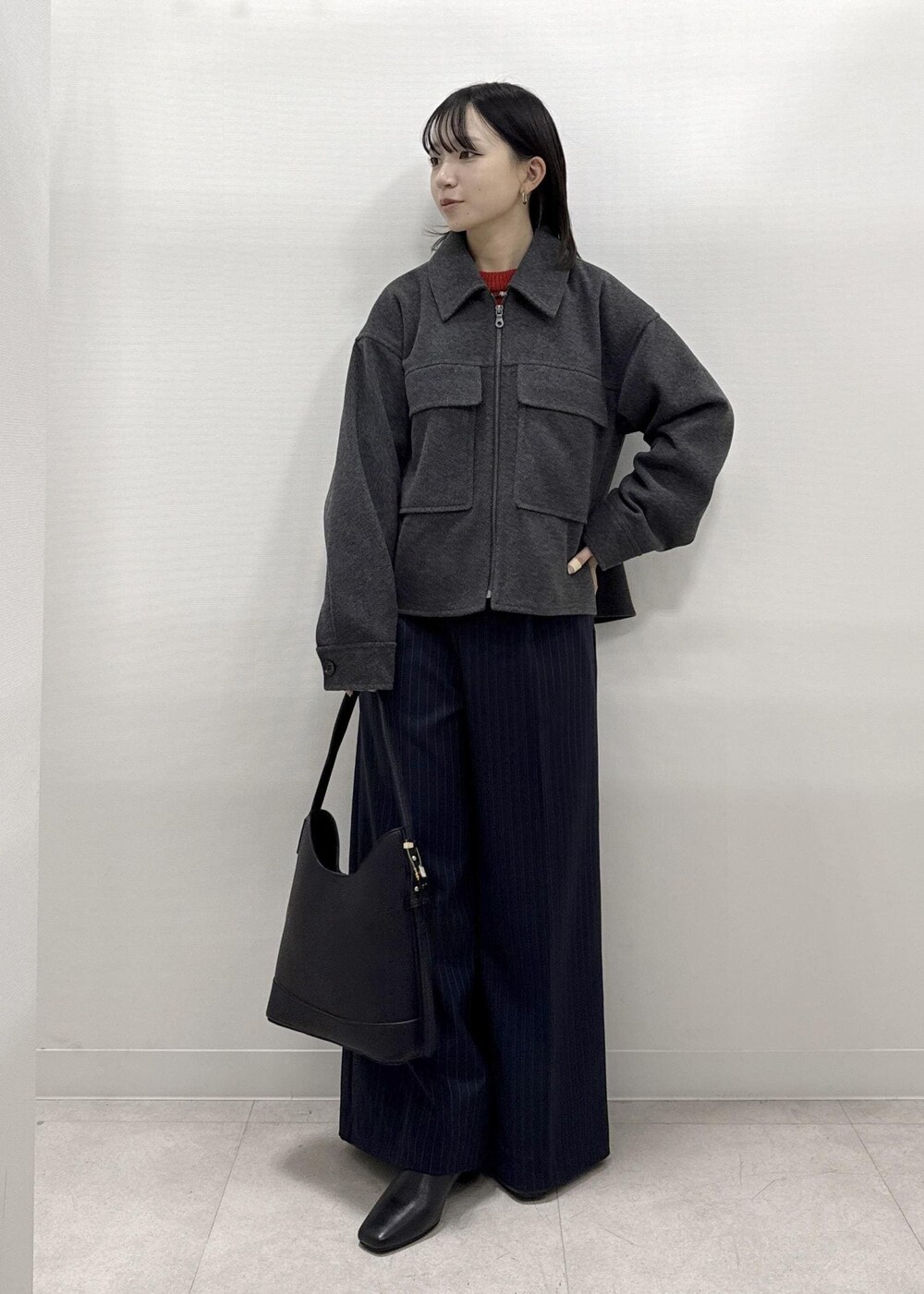 ブラック系のショルダーバッグ、ブルー系のその他パンツ、レッド系のニット/セーターを着用したレディースの秋コーディネートの10枚目の写真