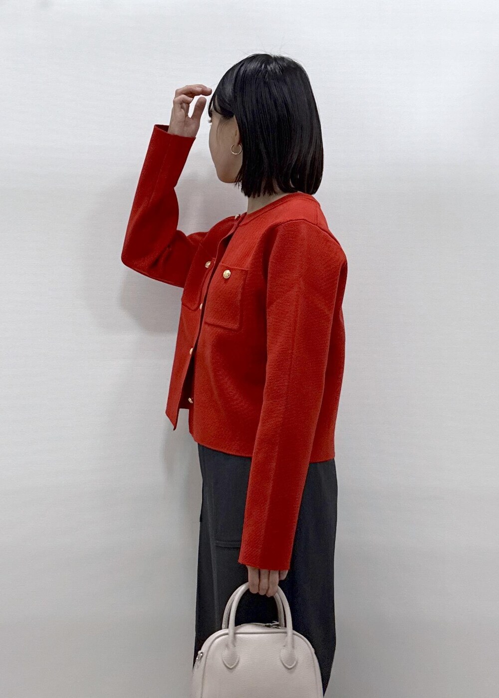 レッド系のカーディガン/ボレロ、グレー系のその他パンツ、ブラック系のローファーを着用したレディースの秋コーディネートの6枚目の写真