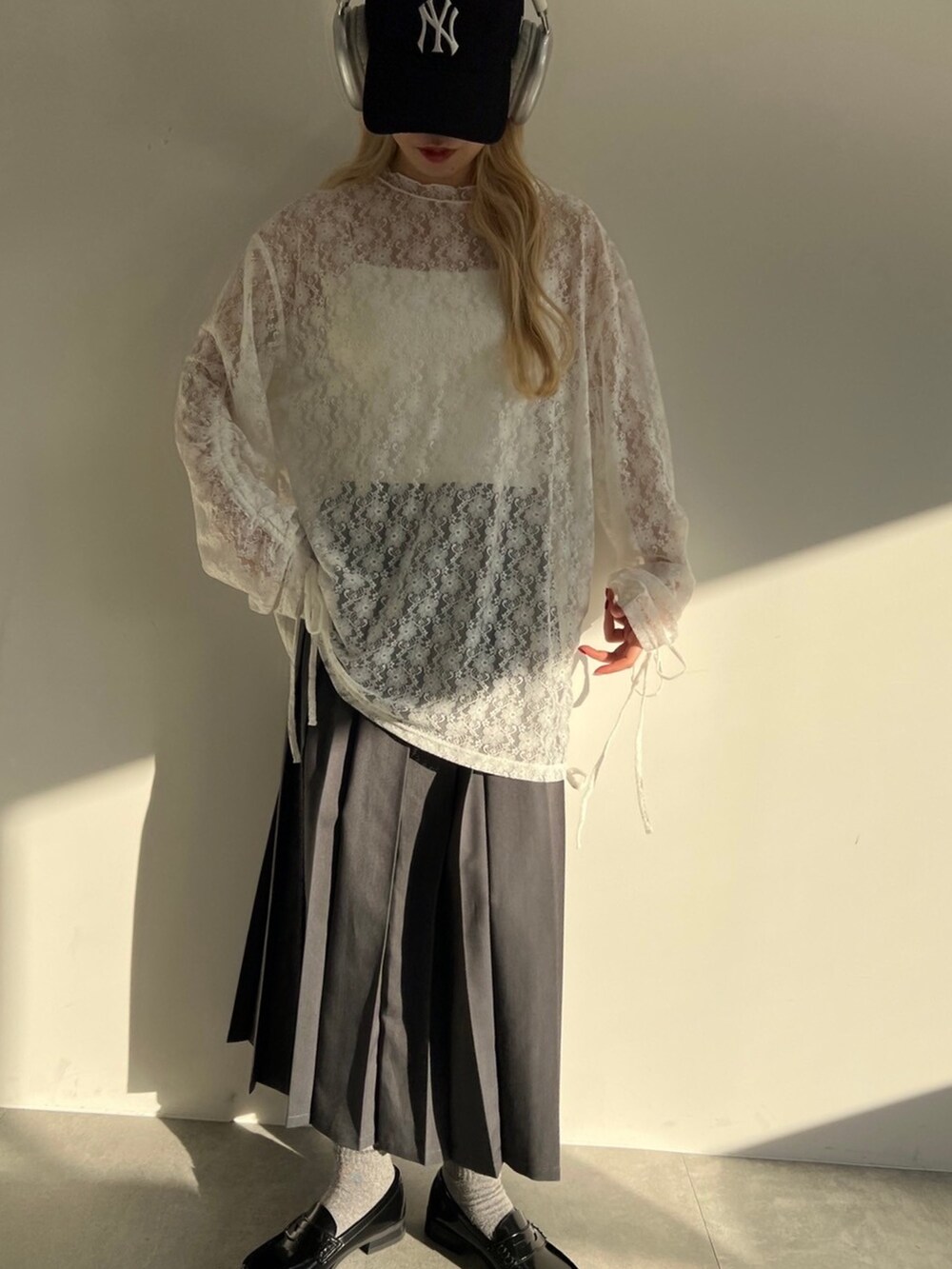 ホワイト系のTシャツ/カットソー、グレー系のスカート、ブルー系のキャップを着用したレディースの春コーディネートの2枚目の写真