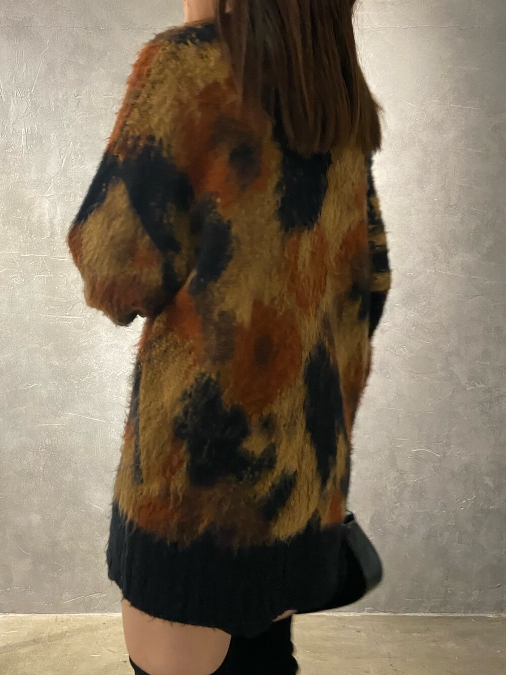 その他のニット/セーター、ブラック系のブーツ、ブラック系のハンドバッグを着用したレディースの秋コーディネートの6枚目の写真