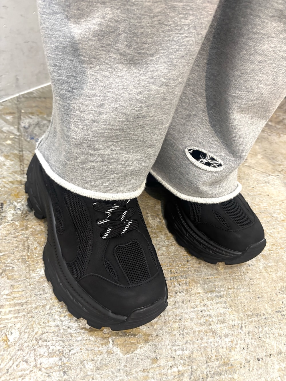 ブラック系のスニーカー、ブラック系のハンドバッグ、ブラック系のTシャツ/カットソーを着用したレディースの夏コーディネートの5枚目の写真