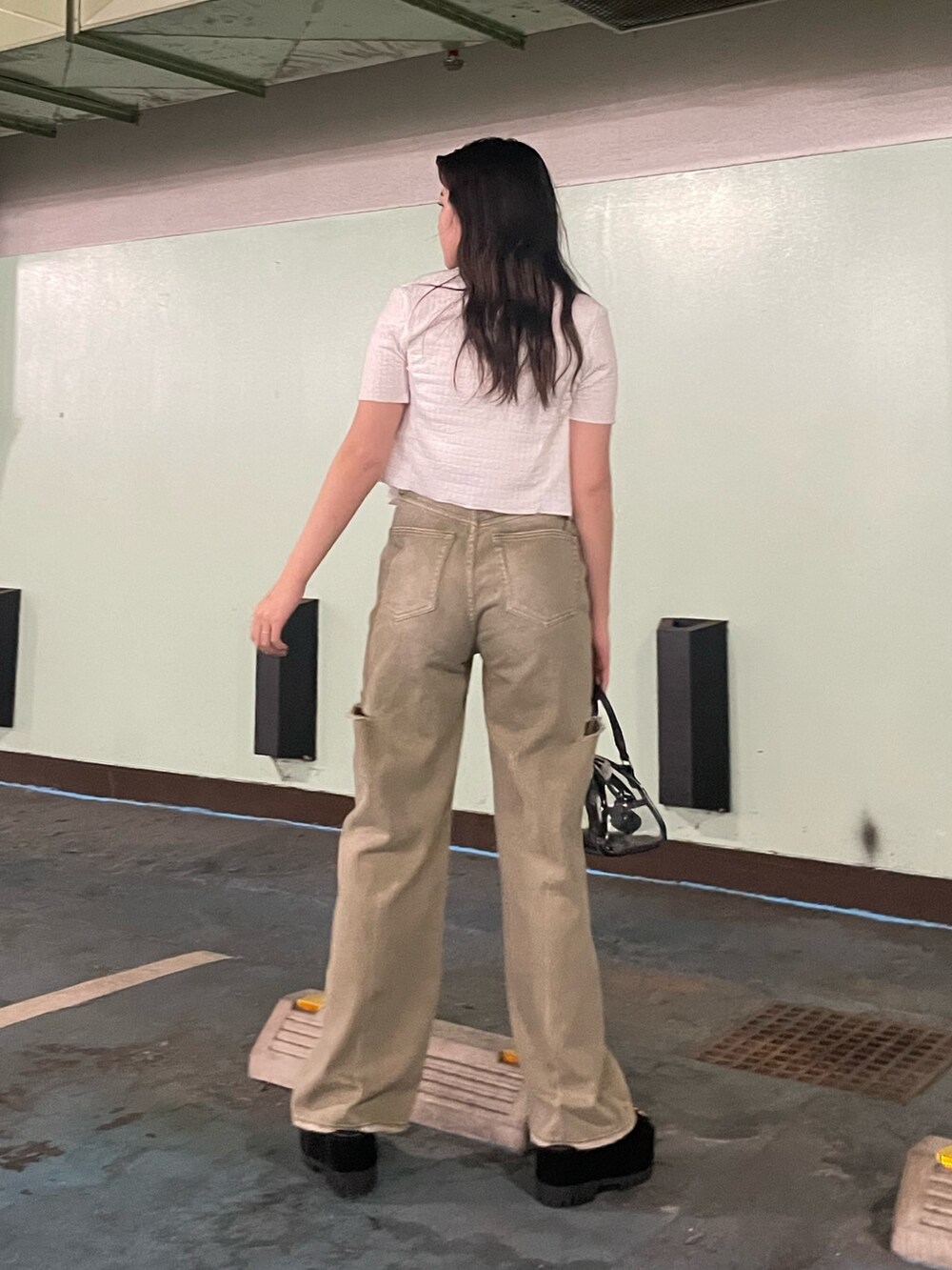 ブラック系のデニムパンツ、その他のハンドバッグ、ホワイト系のアンサンブルを着用したレディースの夏コーディネートの3枚目の写真