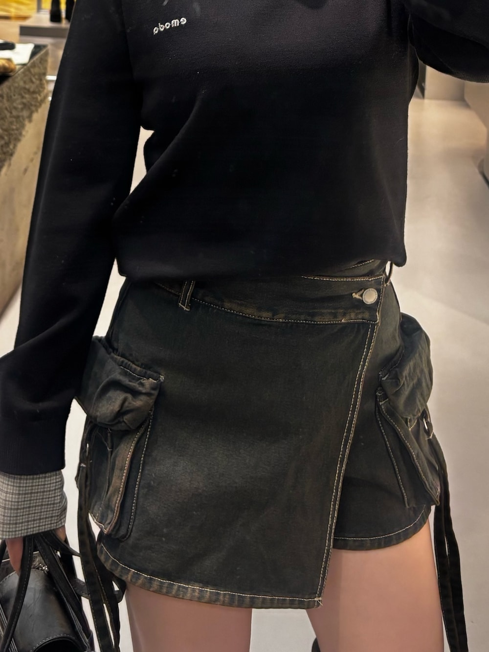 ブラック系のブーツ、ブルー系のその他パンツ、ブラック系のニット/セーターを着用したレディースの冬コーディネートの4枚目の写真