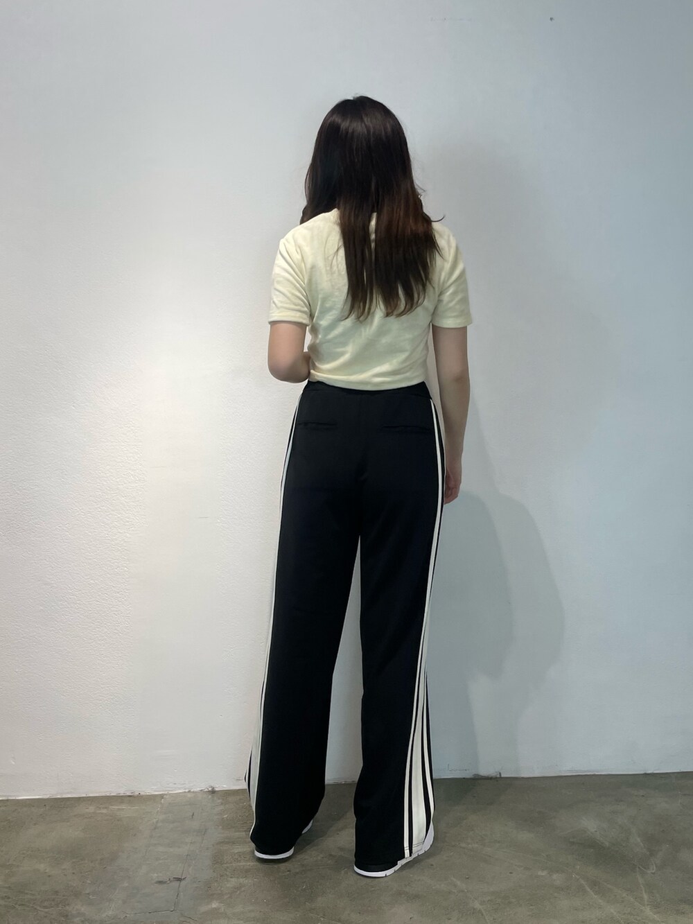 ブラック系のその他パンツ、ホワイト系のTシャツ/カットソー、ブラック系のスニーカーを着用したレディースの夏コーディネートの2枚目の写真