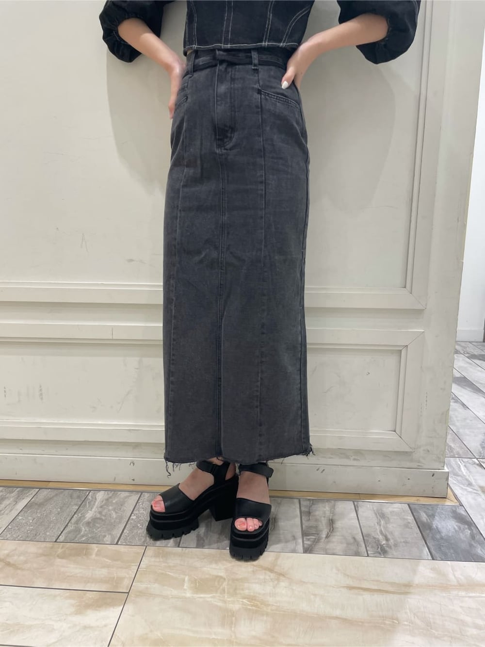 ブラック系のデニムスカート、ブラック系のシャツ/ブラウスを着用したレディースの夏コーディネートの8枚目の写真